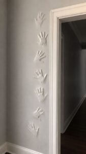 Press Hand Shapes Around a Doorway